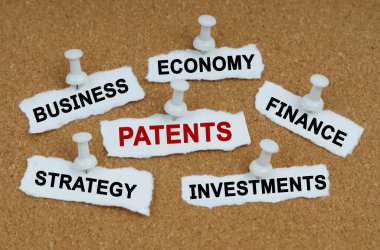 Business concept. On the table there are pieces of paper with the inscriptions - Business, Economics, Finance and PATENTS clipart