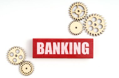 İş konsepti. Beyaz arka planda, dişliler ve Jenga yazılıydı.