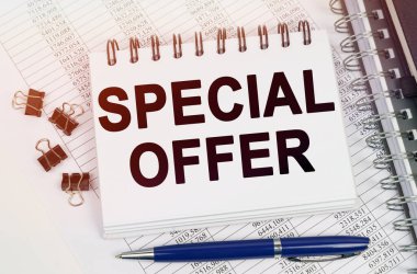 Business concept. On the table is a pen and a notebook with inscriptions - SPECIAL OFFER