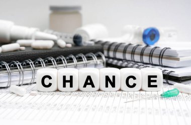 Medicine concept. On the table are diaries, medicines and cubes with the inscription - CHANCE