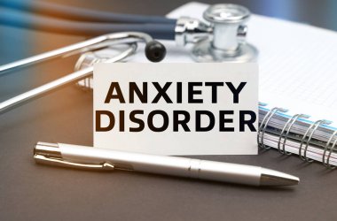 Tıp konsepti. Masanın üzerinde bir günlük, bir steteskop ve üzerinde ANXIETY DISORDER yazan bir kartvizit var.