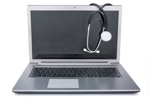 Stethoscope draped on laptop Stock Image