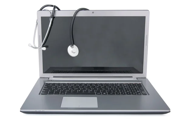 Stethoscope draped on laptop Stock Image