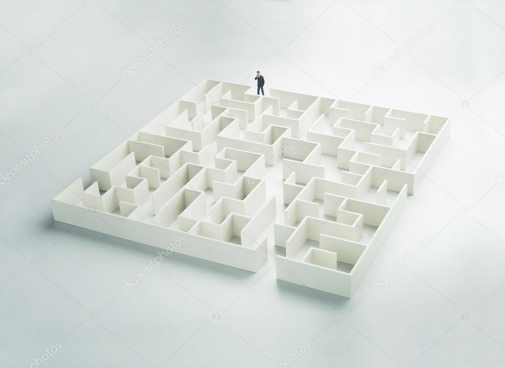 Business challenge. A businessman at the entrance to a maze