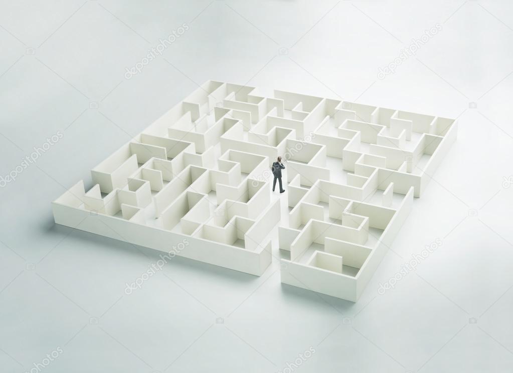 Business challenge. A businessman navigating through a maze