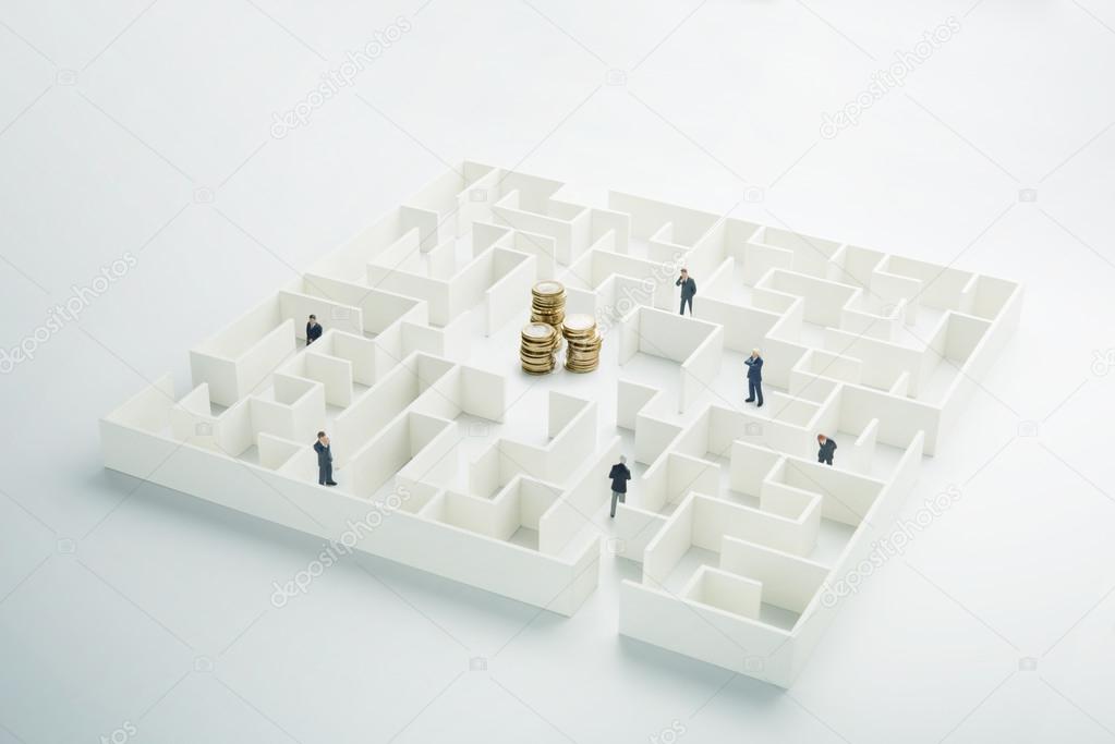 The uncertainty of money and business. Coins stack hidden inside a maze