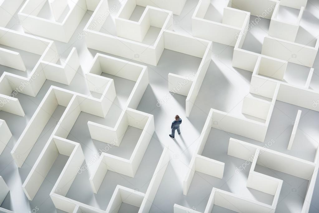 Business challenge. A businessman navigating through a maze