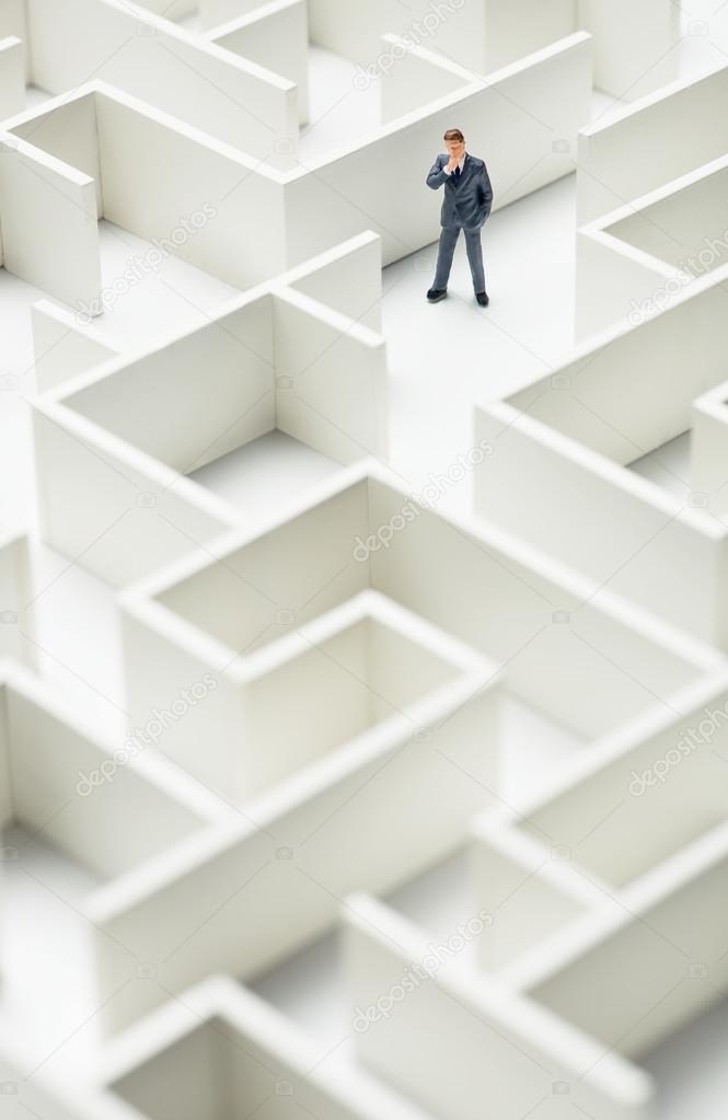 Business challenge. A businessman navigating through a maze