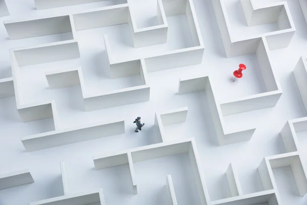 Geschäftsmann auf der Suche nach einem in einem Labyrinth versteckten Ziel — Stockfoto