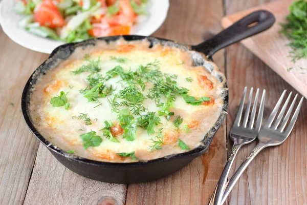 Potato gratin in a pan with mushrooms and fresh herbs on wooden table — Stock Photo, Image