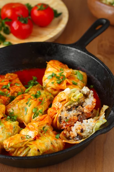 Stuffed cabbage rolls with rice and mushrooms in tomato sauce. Dolma, sarma, or golubtsy - traditional dish of many countries — Stock Photo, Image