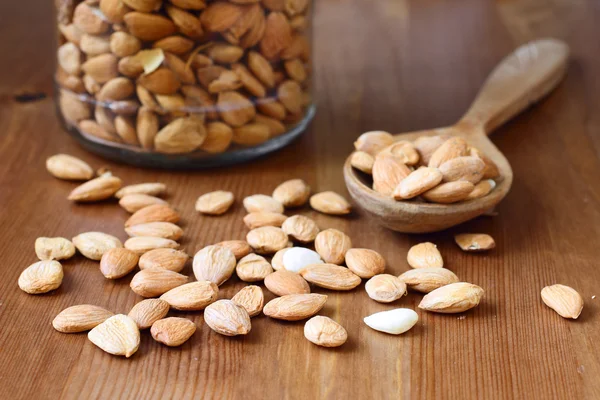 Apricot kernels on wooden background — Zdjęcie stockowe