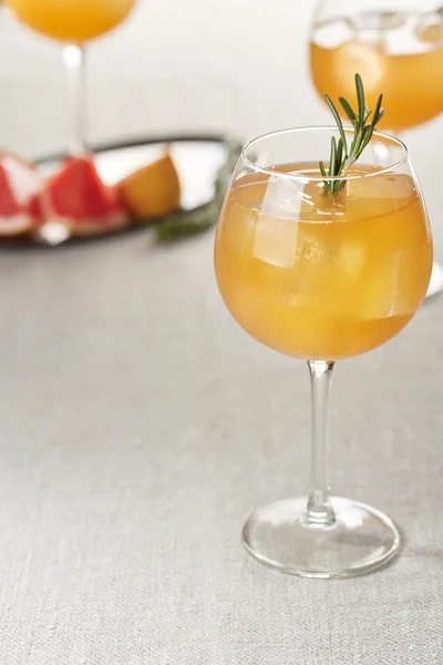 Copas de zumo de pomelo con cubitos de hielo y romero —  Fotos de Stock