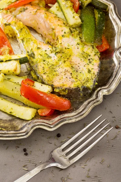 Baked fish on a plate with garnish — Stock Photo, Image