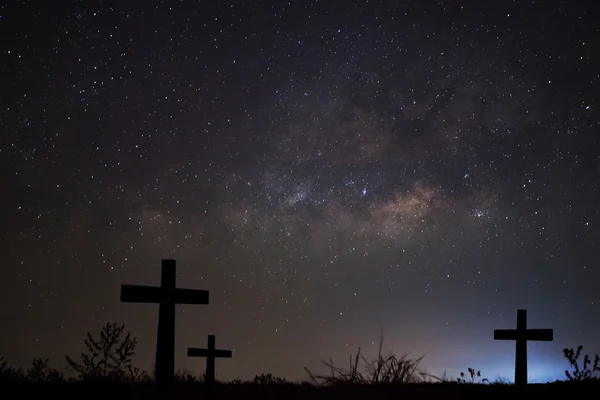 Silhouette of cross over milky way background,Long exposure photograph