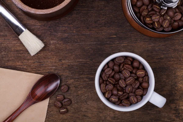 Cup of coffee beans on the brown wooden background — Stock Photo, Image