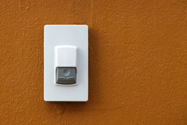 Door bell on brown wall background — Stock Photo, Image