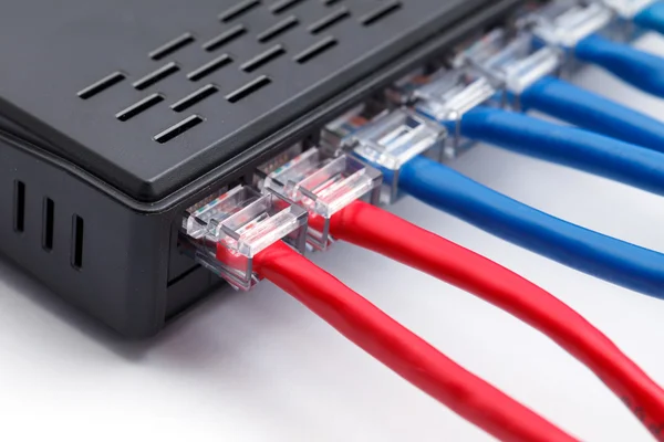 LAN network switch with ethernet cables plugged in — Stock Photo, Image