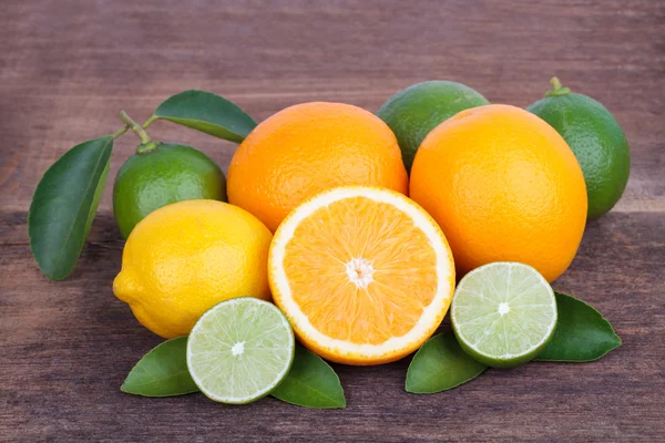 Mix of fresh citrus fruits  on wooden