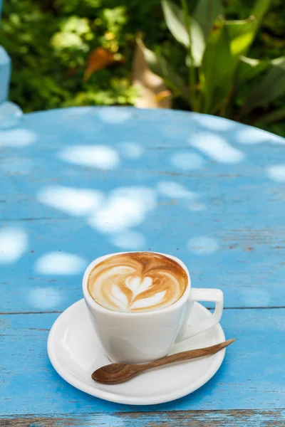 Cup of latte coffee on blue wooden — Stock Photo, Image
