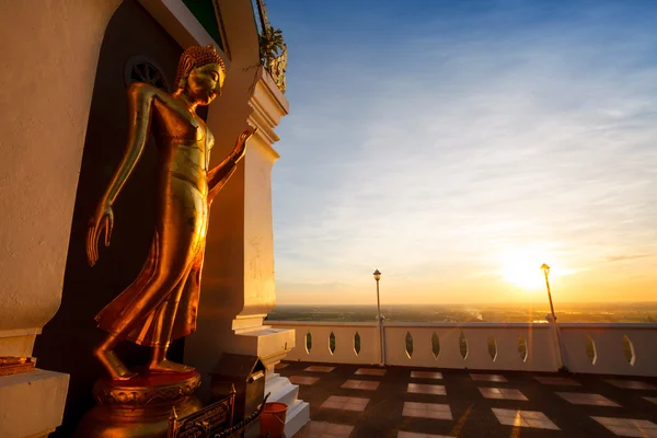 Landscape sunset with standing gold buddha image name is Wat Sra — Stock Photo, Image