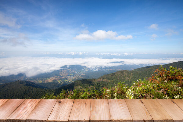 Wood table top on view mountain and blue sky