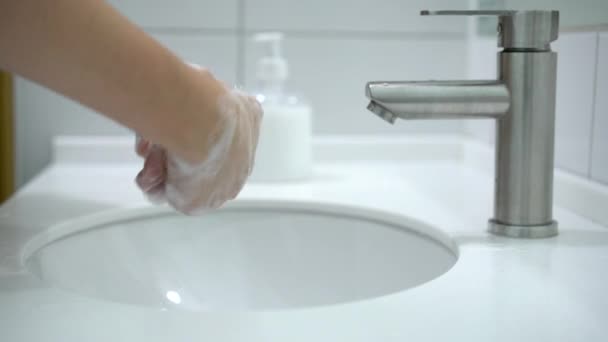 Förebyggande av Coronavirus. En kvinna tvättar händerna noggrant med tvål och varmt vatten hemma. — Stockvideo