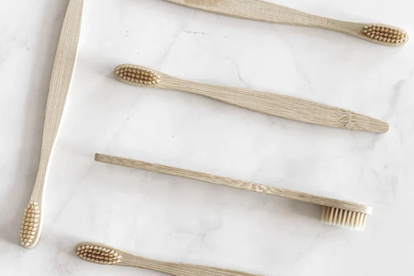 Eco friendly bamboo toothbrushes on marble background. — Stock Photo, Image