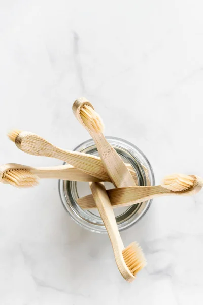 Eco frienrly bamboo toothbrushes on marble background. — Stock Photo, Image