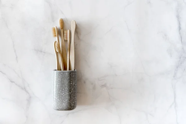 Eco frienrly bamboo toothbrushes on marble background. — Stock Photo, Image