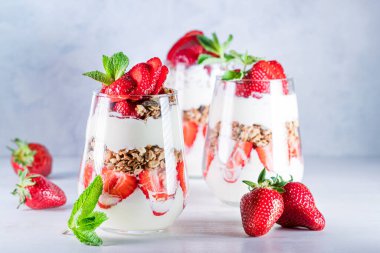 Taze meyve, yoğurt ve granola ile yapılmış çilekli parfe.