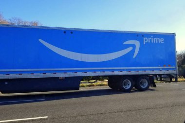 McLean, Virginia, U.S.A - December 6, 2020 - A long Amazon truck on the highway clipart