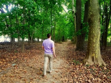 A young guy walking on the hiking trail at Bellevue State Park, Wilmington, Delaware, U.S.A