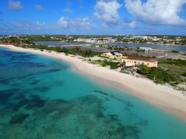 The aerial view of the resorts along the shore with private white beaches near Grand Turk, Turks & Caicos