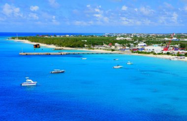The view of beautiful blue ocean, boats and white sandy beaches along the bay near Grand Turk, Turks & Caicos
