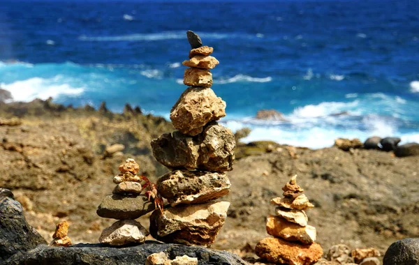 Multiple sizes of balancing rocks along the ocean in Aruba