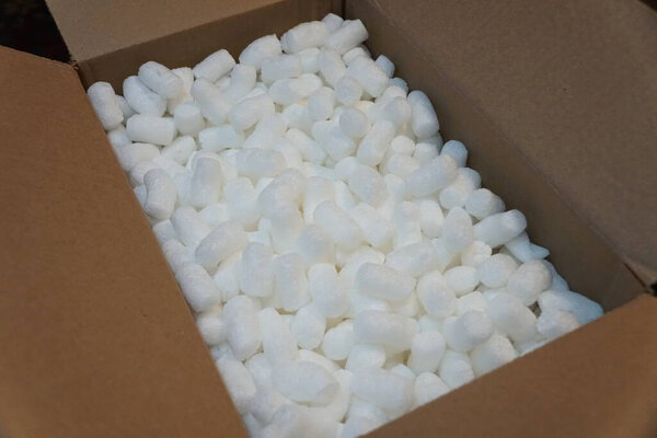 White packing peanuts inside a brown box