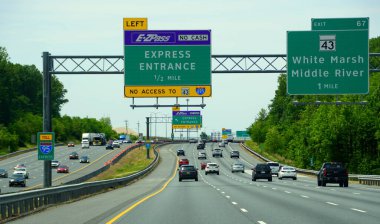Aberdeen, Maryland, U.S.A - May 17, 2021 - The traffic on Interstate 95 towards EZPass Express Entrance into Interstate 695 clipart