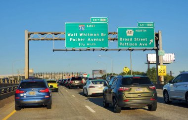 Philadelphia, Pennsylvania - Oct 1, 2025 - Highway traffic approaching Exit 19 for I-76 East to Walt Whitman Bridge and Packer Avenue, and Exit 17 for Route 611 North to Broad Street and Pattison Avenue