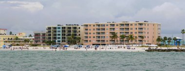 Madeira Sahili, Florida, ABD - 11 Kasım 2025 - Pastel sahildeki oteller güneşli bir günde kabinlere, şemsiyelere ve palmiye ağaçlarına bakar
