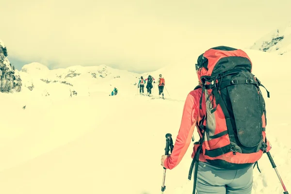 Ski tourer op een groep skiërs. — Stockfoto