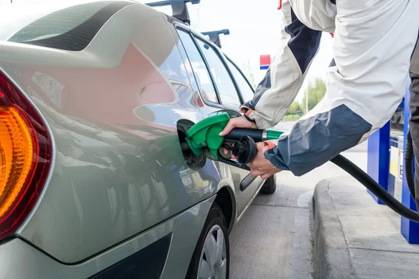 Pumping gas. Hand holding fuel nozzle. — Stock Photo, Image