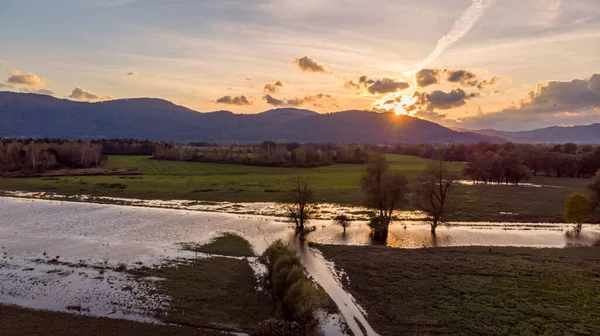 Spectacular aerial panorama of river flowing through fields at sunset. — Stock Photo, Image