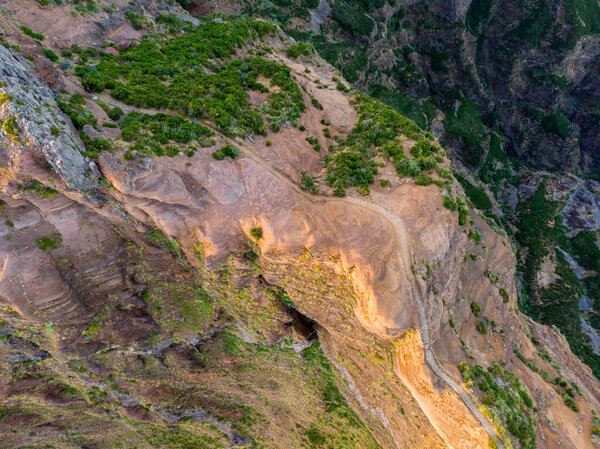 Drop down view of trail following volcanic mountain ridge.