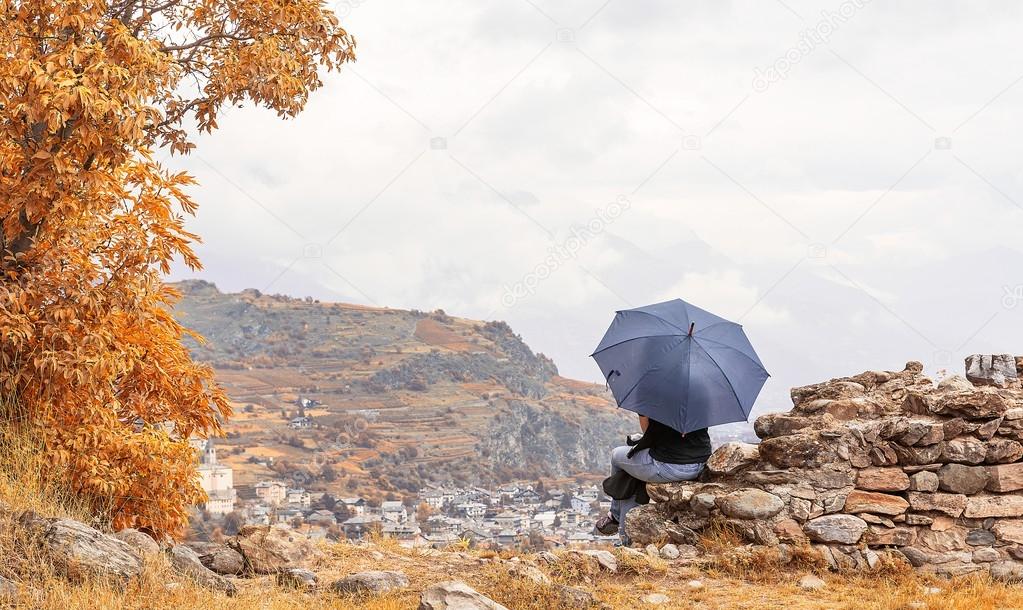 Sitting girl holding an umbrella 