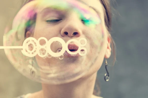 Girl blowing bubbles. — Stock Photo, Image