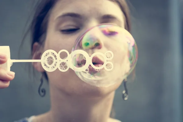 Girl blowing bubbles. — Stock Photo, Image