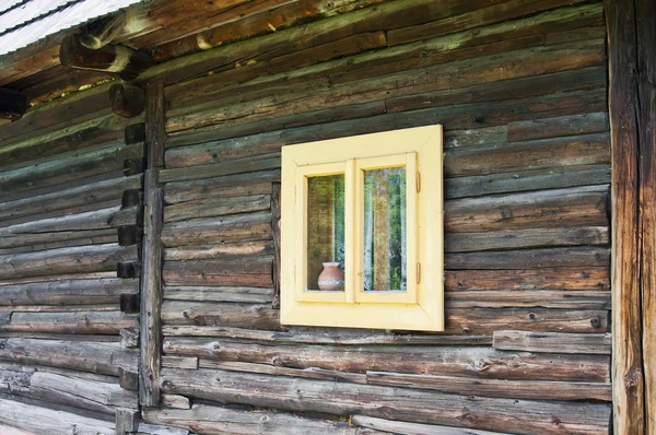 Small light window on a chalet — Stock Photo, Image
