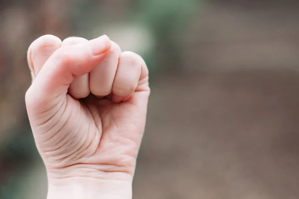 Close-up photo of female fist. Fight for women rights. Space for text