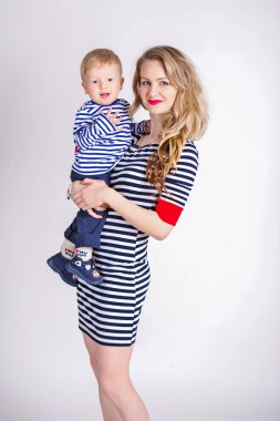 Mother with her son in her arms, blond, smiling, striped clothes, the family sailor